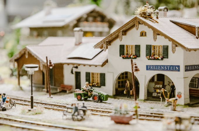 Miniature railway station with tracks in the foreground