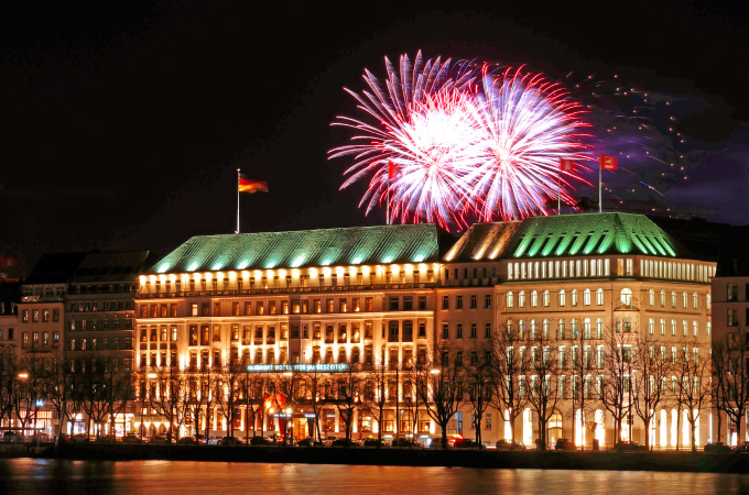 Photo taken across the Inner Alster with a view of the Hotel Vier Jahreszeiten and fireworks in the sky